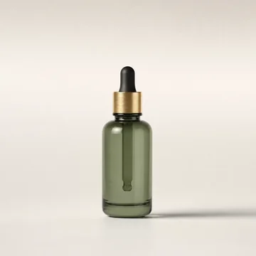 Frasco gotero de vidrio verde salvia con perilla oscura y aro dorado