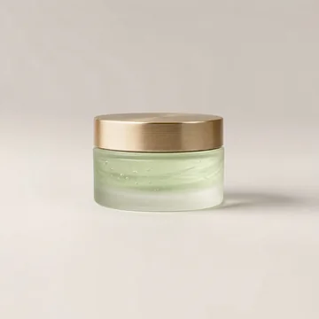 Tarro de vidrio esmerilado con gel verde claro y tapa dorada